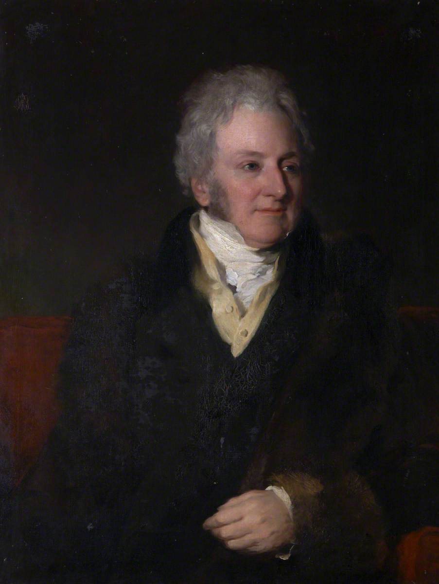 Portrait of a grey-haired man in a dark coat