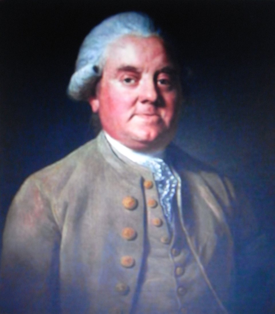 Portrait of a man in a grey coat with a powdered wig